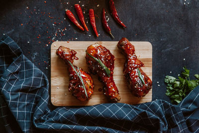 High angle view of chili peppers on cutting board