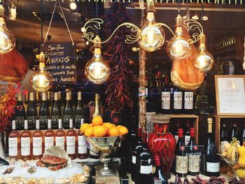 Illuminated lanterns hanging at market stall for sale