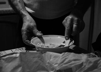 Midsection of man preparing food on table