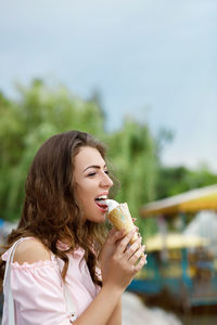 Smiling young woman drinking juice