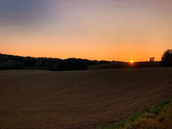 Scenic view of field against sky during sunset