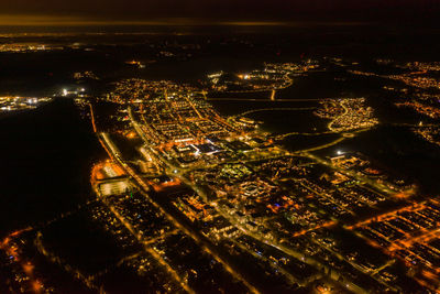 Aerial view of illuminated buildings in city at night