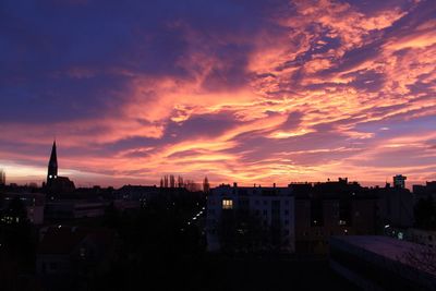 High angle view of buildings against cloudy sky during sunset