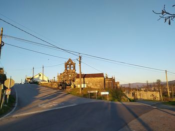 Road by city against clear sky