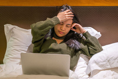 Young woman using laptop at home