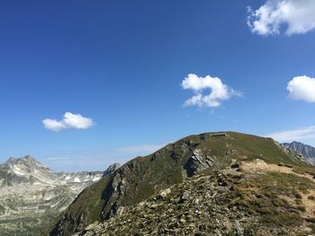 Low angle view of mountain against blue sky