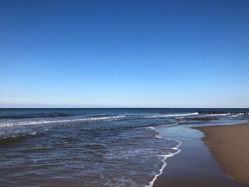 Scenic view of sea against clear blue sky