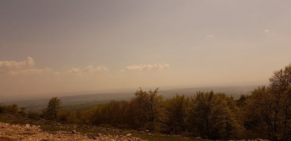 Scenic view of land against sky during sunset