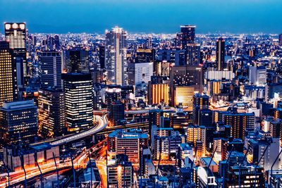 High angle view of city lit up at night