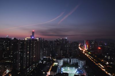 High angle view of illuminated buildings against sky at night