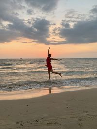 Girl jumps on the beach