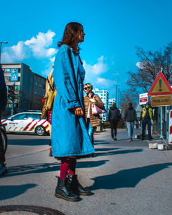 Full length of woman walking on road in city