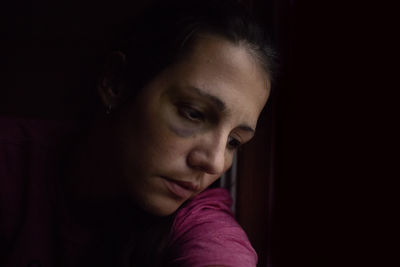 Close-up portrait of a woman looking away