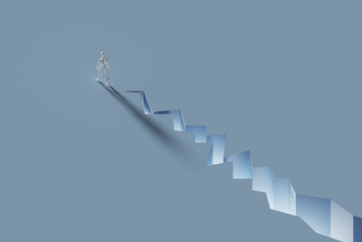 Low angle view of spiral staircase against white background