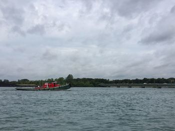 Scenic view of calm sea against cloudy sky