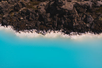 Scenic view of sea against rock formation