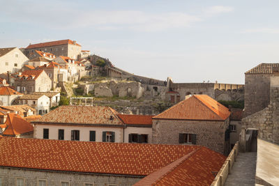 Houses in town against sky