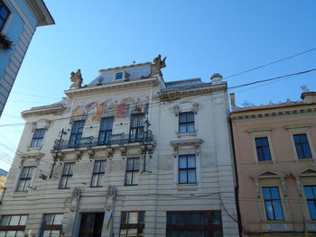 Low angle view of building against clear blue sky