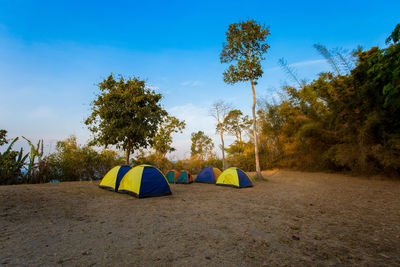 Tent in field against blue sky