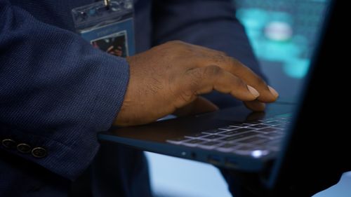 Midsection of man using laptop