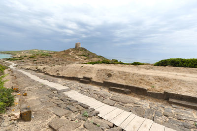 View of stone wall against cloudy sky