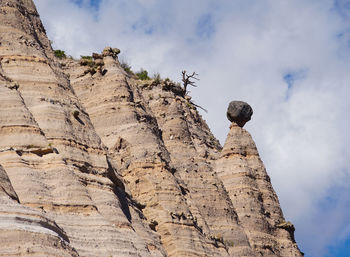 Low angle view of rock formation against sky