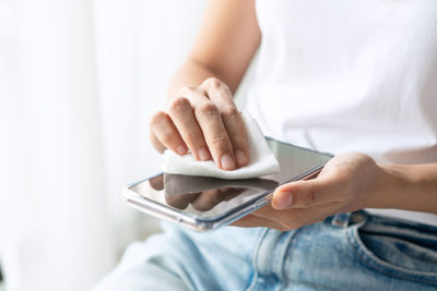 Midsection of man using mobile phone