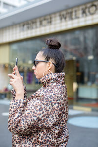 Woman photographing in city