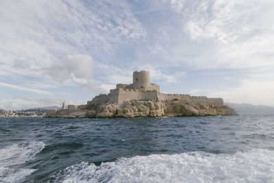 Castle by sea against sky