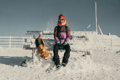 Portrait of man standing on snow covered field