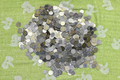 High angle view of coins on grass