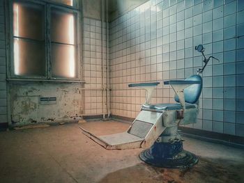 Empty chair in abandoned building