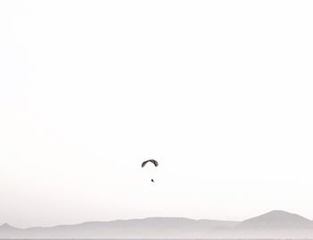 Low angle view of person against clear sky