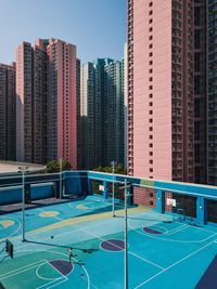 View of swimming pool against buildings in city