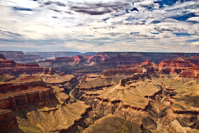 Aerial view of dramatic landscape against cloudy sky
