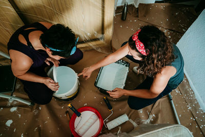 High angle view of women sitting on wall