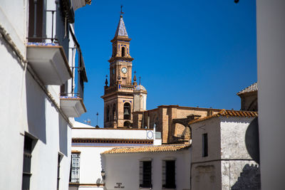 Low angle view of buildings against blue sky