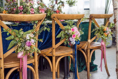 Decorated chairs during wedding ceremony