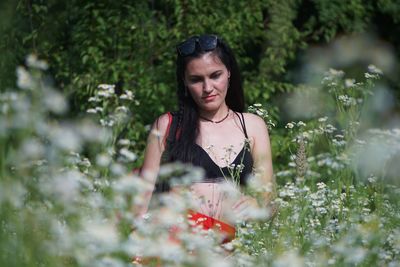 Young woman with pink flower plants