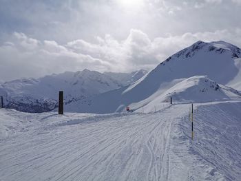 Scenic view of snow covered mountains against sky