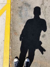 Shadow of a man on asphalt