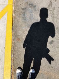 Low section of man standing on road