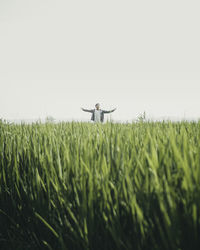 Man standing on field against clear sky