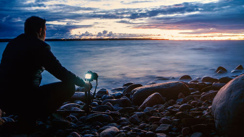 Rear view of woman looking at sea against sky