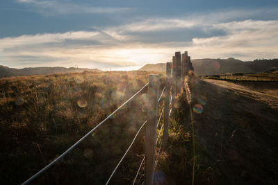 Panoramic view of railroad tracks against sky during sunset