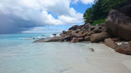 Rocks on beach against sky