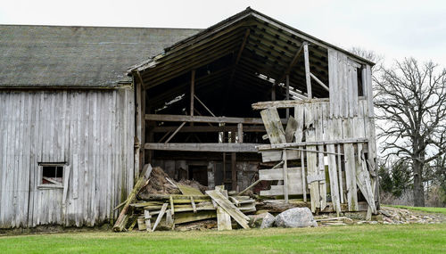 Old abandoned house on field against building