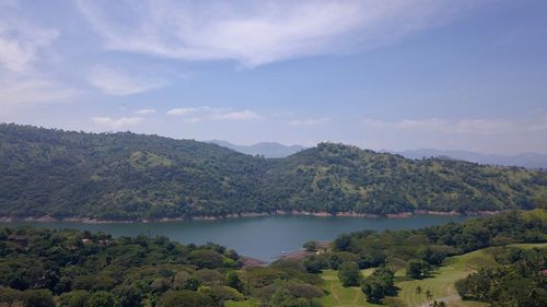 Scenic view of lake and mountains against sky