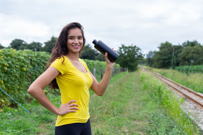 Young woman exercising on field