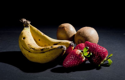 Close-up of fruits against black background